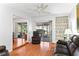 Living room with hardwood floors, access to screened patio, and built-in shelving at 2823 Cady Way, Winter Park, FL 32792