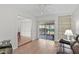 Cozy living room with built-in shelving, wood floors, and access to the patio at 2823 Cady Way, Winter Park, FL 32792