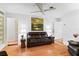 Living room with hardwood floors, leather couches, and a large piece of art at 2823 Cady Way, Winter Park, FL 32792