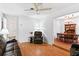 Bright living room with hardwood floors, leather furniture, and view into dining room at 2823 Cady Way, Winter Park, FL 32792