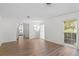Bright living room with natural light, wood floors, and access to a bedroom at 2823 Cady Way, Winter Park, FL 32792