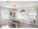 Farmhouse style dining room with a wooden table and bench at 2949 Muller Oak Loop, Ocoee, FL 34761