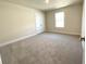 Spacious bedroom with neutral carpeting and ample natural light at 3019 Tackle Drive, Leesburg, FL 34748