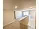 Upstairs hallway with neutral carpeting and access to bedrooms at 3019 Tackle Drive, Leesburg, FL 34748