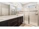 Bathroom with double vanity, shower and frameless glass enclosure at 308 Vestrella Dr, Kissimmee, FL 34759