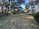 Large grassy backyard with mature trees and a storage shed at 3663 Lomond Ct, Apopka, FL 32712