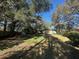 Large backyard with lush trees and grassy lawn at 3663 Lomond Ct, Apopka, FL 32712