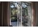 View of an enclosed patio and backyard through sliding glass doors at 3663 Lomond Ct, Apopka, FL 32712