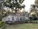 House exterior showcasing stone accents, palm trees, and manicured lawn at 3663 Lomond Ct, Apopka, FL 32712