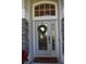 Elegant front door with glass accents and a welcoming wreath at 3663 Lomond Ct, Apopka, FL 32712