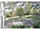 Private patio with lush landscaping and a small tree at 3663 Lomond Ct, Apopka, FL 32712