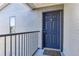 Dark blue apartment entry door with a metal railing at 3756 Idlebrook Cir # 206, Casselberry, FL 32707