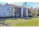 Exterior of a light blue two-story building with balconies and landscaping at 3756 Idlebrook Cir # 206, Casselberry, FL 32707