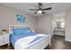 Main bedroom with white bed frame and dark wood floors at 3756 Idlebrook Cir # 206, Casselberry, FL 32707