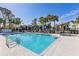 Inviting community pool with a hot tub and lounge chairs at 3756 Idlebrook Cir # 206, Casselberry, FL 32707