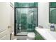 Bathroom with green tile shower and green vanity at 405 Kehoe Blvd, Orlando, FL 32825