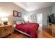 Main bedroom with king-size bed, terracotta tile floors and en-suite bathroom at 405 Kehoe Blvd, Orlando, FL 32825