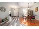 View of the dining area, showcasing wood-look floors and a charming table set at 405 Kehoe Blvd, Orlando, FL 32825