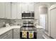 Modern kitchen with gray cabinets, stainless steel appliances and quartz countertops at 405 Kehoe Blvd, Orlando, FL 32825