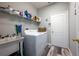 Laundry room with washer, dryer, shelving and utility sink at 405 Kehoe Blvd, Orlando, FL 32825