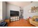 Living room features a large TV, built-in shelving and terracotta tile floors at 405 Kehoe Blvd, Orlando, FL 32825