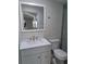 Updated bathroom with modern vanity and large mirror at 4220 Lancashire Ln, Orlando, FL 32812