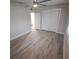 Bright bedroom with wood-look floors, double doors to closet and access to bathroom at 4220 Lancashire Ln, Orlando, FL 32812