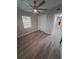 Bright bedroom with gray vinyl flooring and ceiling fan at 4220 Lancashire Ln, Orlando, FL 32812