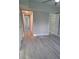 Bright hallway with light grey walls and wood-look floors at 4220 Lancashire Ln, Orlando, FL 32812