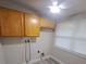 Laundry room with wood cabinets and vinyl flooring at 4220 Lancashire Ln, Orlando, FL 32812