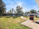 Landscaped backyard with patio, grill, and shed at 4304 Mizell St, Orlando, FL 32812