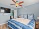 Main bedroom with king bed, en-suite bathroom, and TV at 4304 Mizell St, Orlando, FL 32812