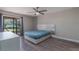 Main bedroom with sliding door to patio, ceiling fan, and wood-look flooring at 447 Stanton Pl, Longwood, FL 32779