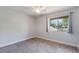 Spacious bedroom with neutral walls, carpeted floors, and a window with natural light at 447 Stanton Pl, Longwood, FL 32779