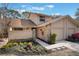 Front view of a tan two-story townhome with a walkway and attached garage at 447 Stanton Pl, Longwood, FL 32779