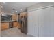 Bright kitchen with stainless steel refrigerator, ample cabinetry, and tile flooring at 447 Stanton Pl, Longwood, FL 32779