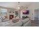 Open living room with L-shaped sofa, fireplace, and large TV at 447 Stanton Pl, Longwood, FL 32779