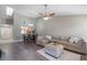 Open concept living room and dining area with L-shaped sofa and hardwood floors at 447 Stanton Pl, Longwood, FL 32779