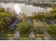 Aerial view of three homes situated by a lake at 452 Misty Oaks Run, Casselberry, FL 32707