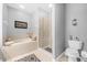 Bathroom with a soaking tub, glass shower, and updated fixtures at 452 Misty Oaks Run, Casselberry, FL 32707