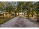 Brick path through a tree-lined community with playground in the background at 452 Misty Oaks Run, Casselberry, FL 32707