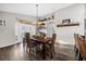 A dining room showcasing a wooden table and wicker chairs near a patio at 452 Misty Oaks Run, Casselberry, FL 32707