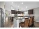 Modern kitchen featuring granite countertops, dark cabinetry, and stainless steel appliances at 452 Misty Oaks Run, Casselberry, FL 32707