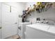 Laundry room with washer, dryer, and ample storage shelves at 452 Misty Oaks Run, Casselberry, FL 32707