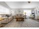 Living room featuring a neutral color scheme, plush seating, and ample natural light at 452 Misty Oaks Run, Casselberry, FL 32707