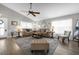 Living room with comfortable seating, large windows, and a neutral color scheme at 452 Misty Oaks Run, Casselberry, FL 32707