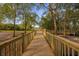 Wooden boardwalk leading to a serene waterfront view in a natural setting at 452 Misty Oaks Run, Casselberry, FL 32707