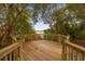 Elevated wooden deck overlooking a peaceful lake, perfect for relaxation at 452 Misty Oaks Run, Casselberry, FL 32707