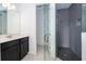 Modern bathroom with dark gray herringbone tile shower and quartz vanity at 4767 Cragmere Loop, Clermont, FL 34711