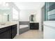 Bathroom with soaking tub, double vanity, and gray tile at 4767 Cragmere Loop, Clermont, FL 34711